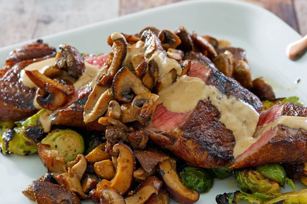 Seared Steak with Sautéed Mushrooms & Brussels Sprouts with a Brandy Peppercorn Cream Sauce