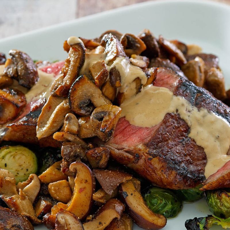 Seared Steak with Sautéed Mushrooms & Brussels Sprouts with a Brandy Peppercorn Cream Sauce